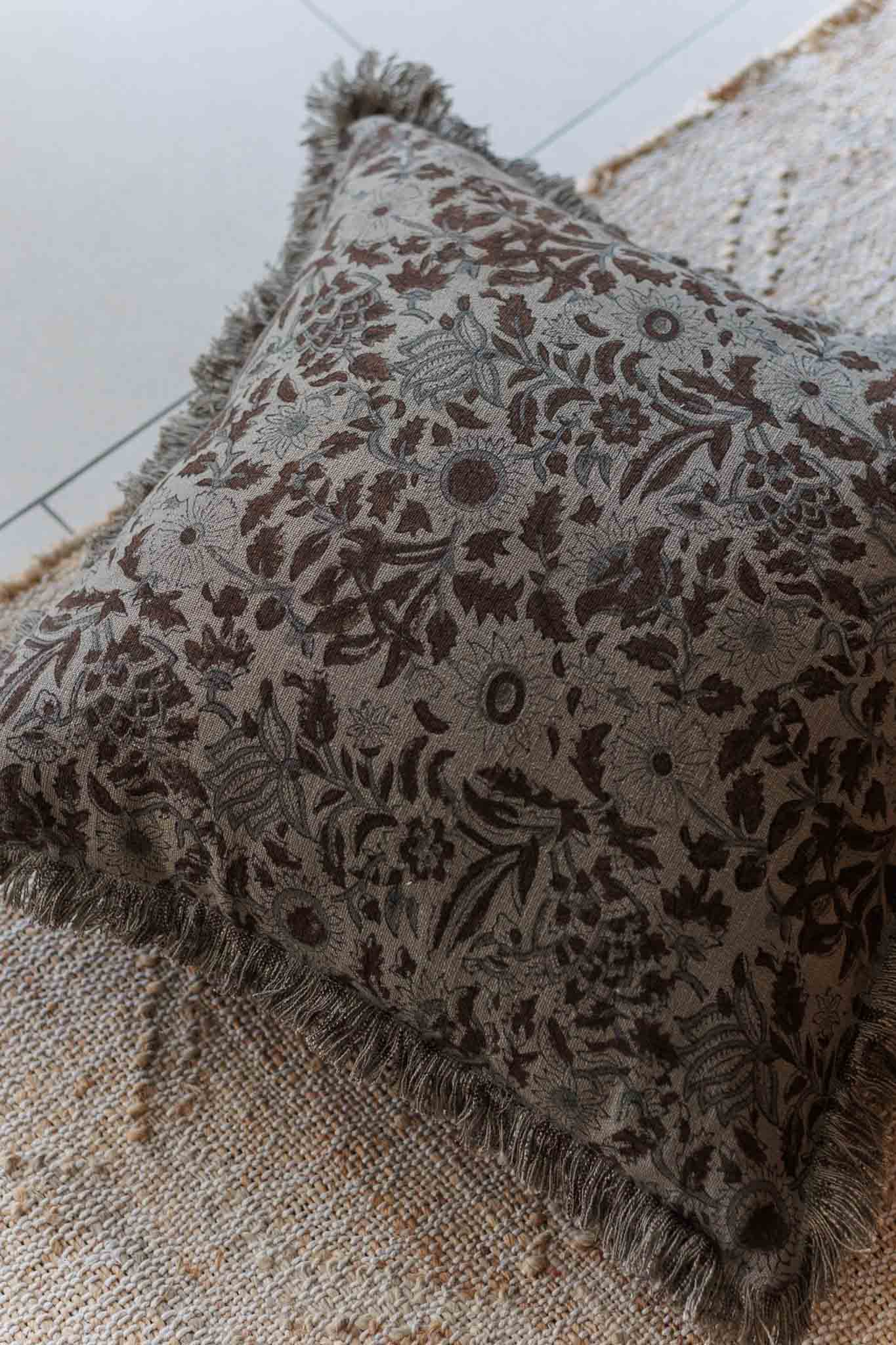 Decorative pillow with floral pattern on a textured surface