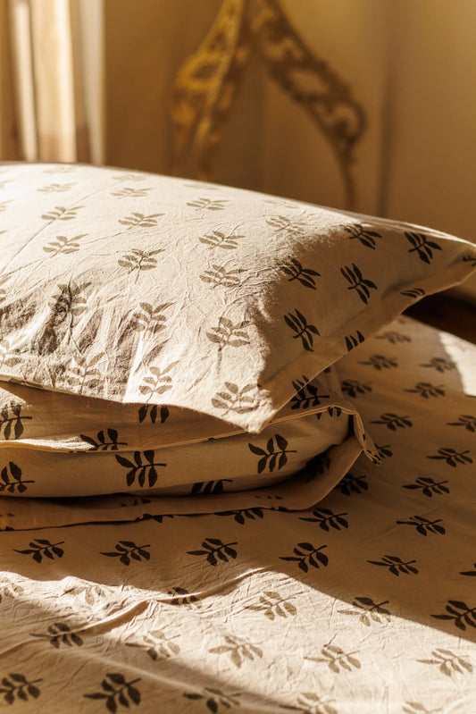 cotton pillows on a bed with sunlight streaming over them