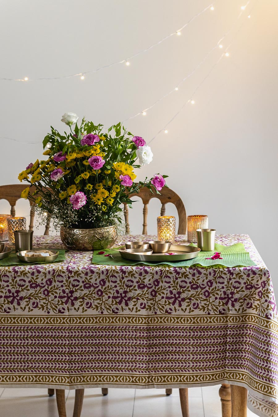 A Block Print Tablecloth dressed up with a Flowers, Brass Crockery and cutlery for festival time
