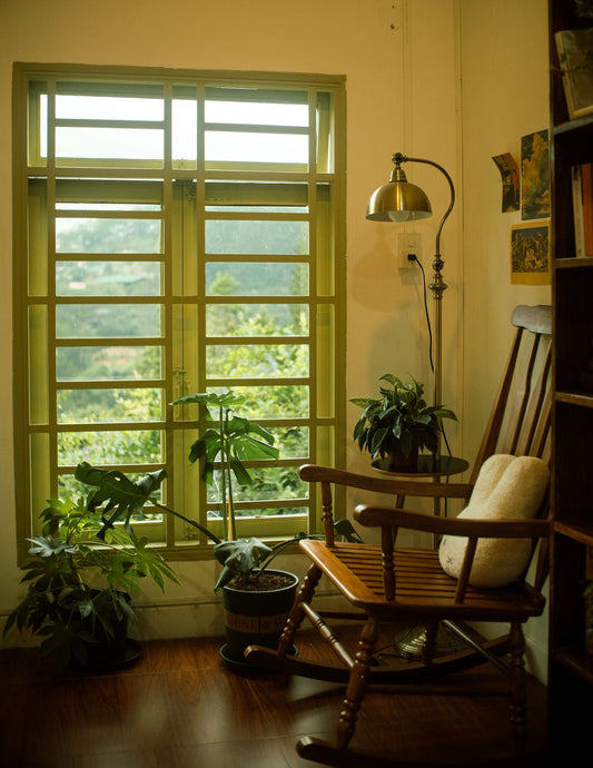 Cozy Reading nook with wooden chair and cushion and plants