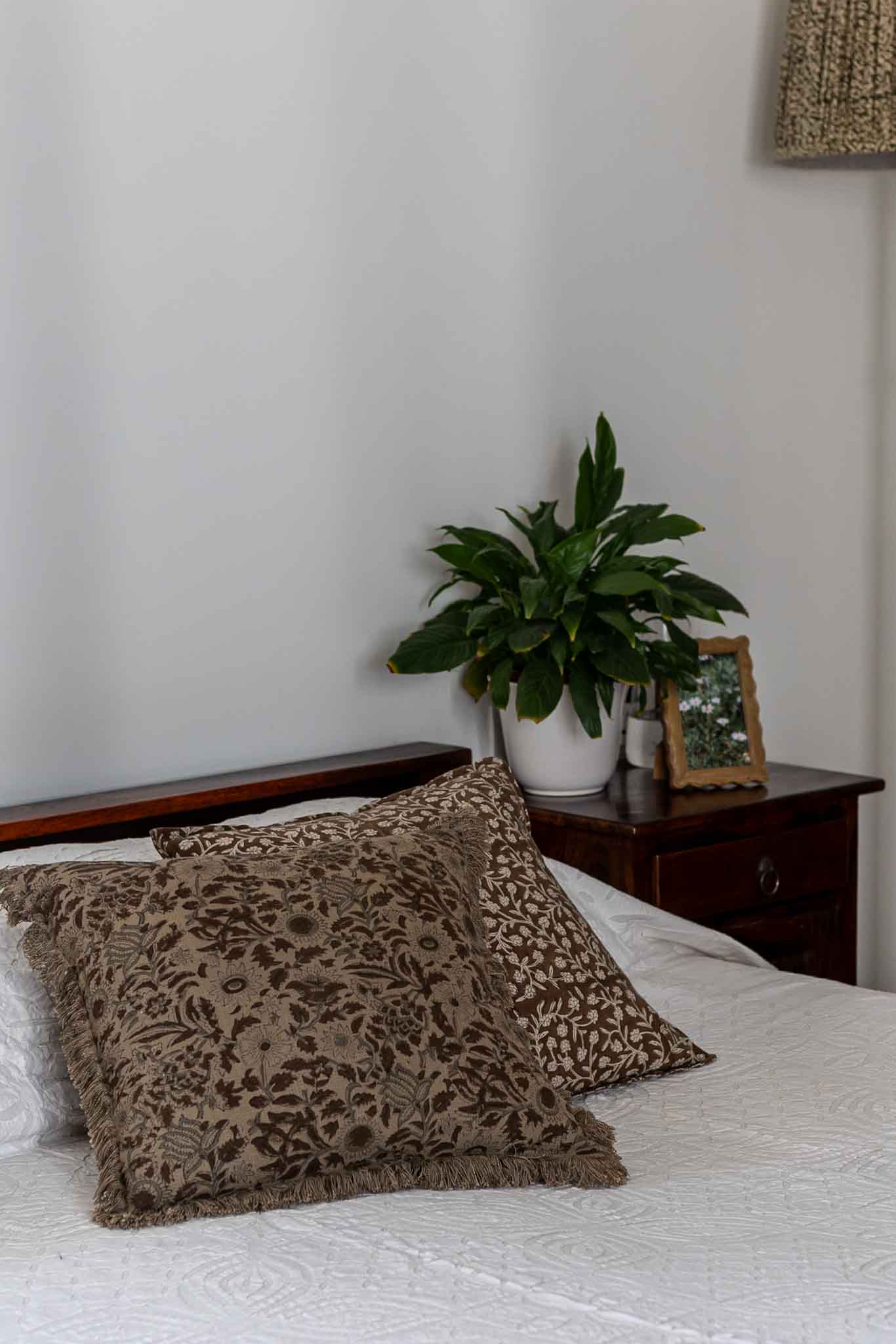 Decorative block print pillow in olive green floral pattern 