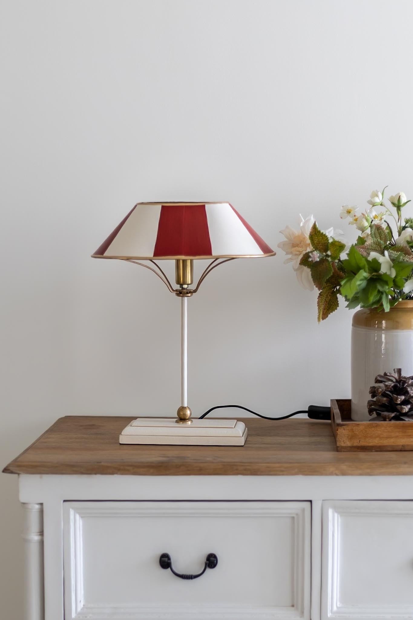 The Bistro Stripe Table Lamp on a console with vintage décor and framed art