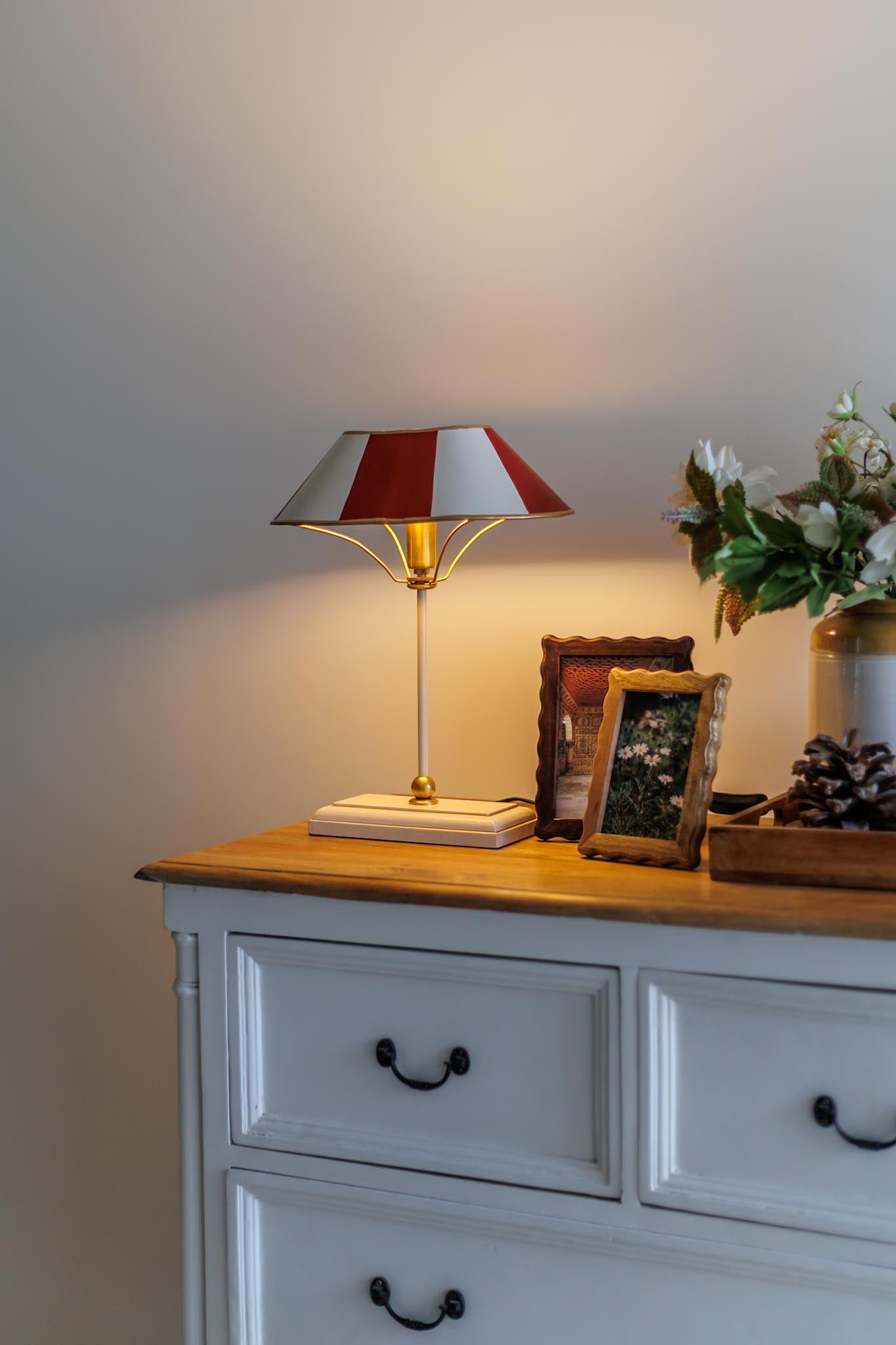 Striped table lamp styled in a cottage-inspired console setup