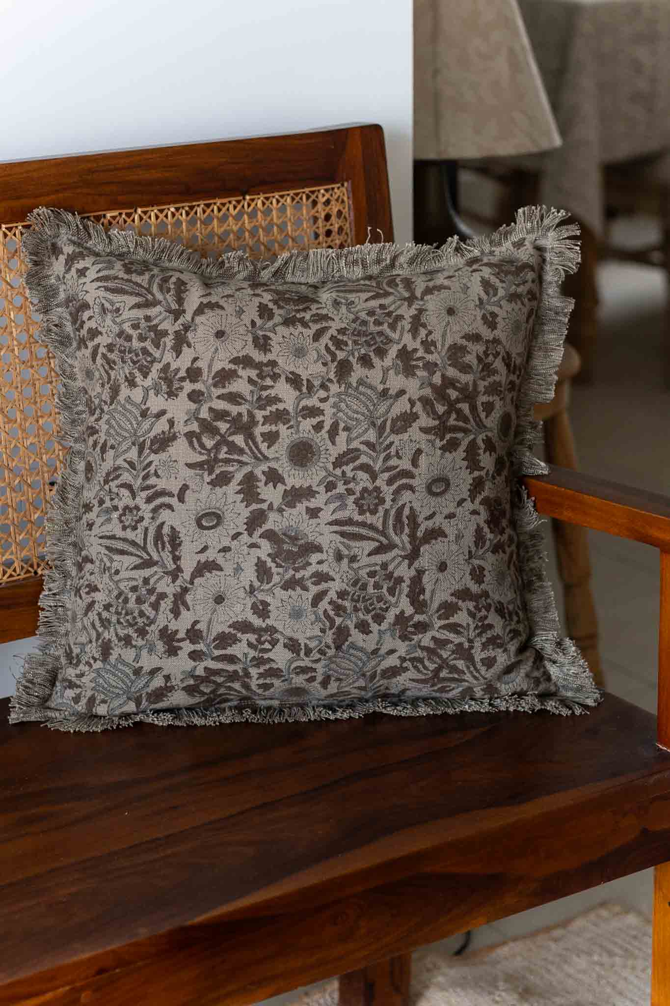 Decorative pillow with floral pattern on a wooden chair