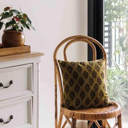 Block print cushion cover in Olive green colour on soft velvet cotton on a chair 