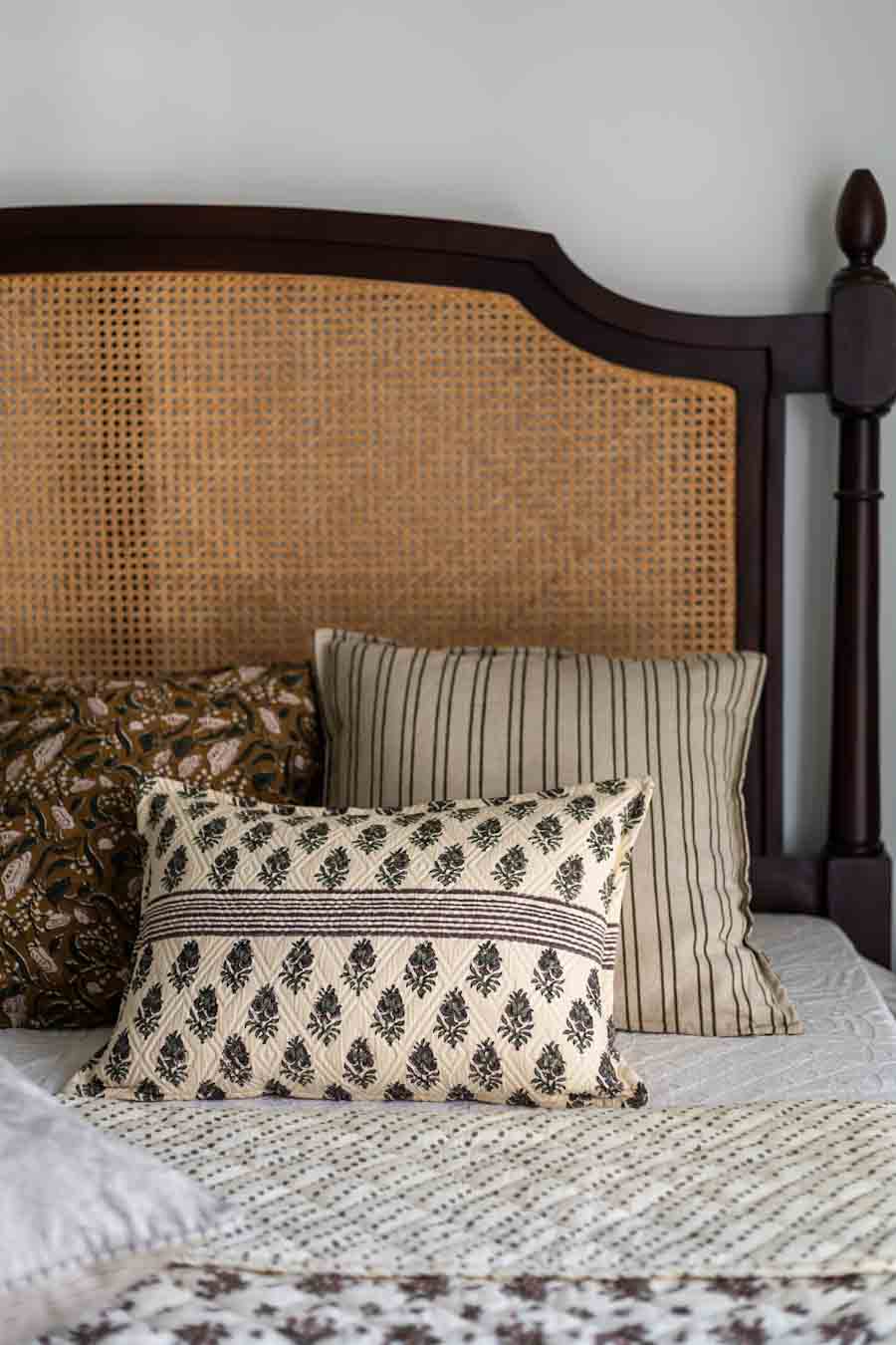 Set of Block Print Cushion covers on a Bed with Rattan frame