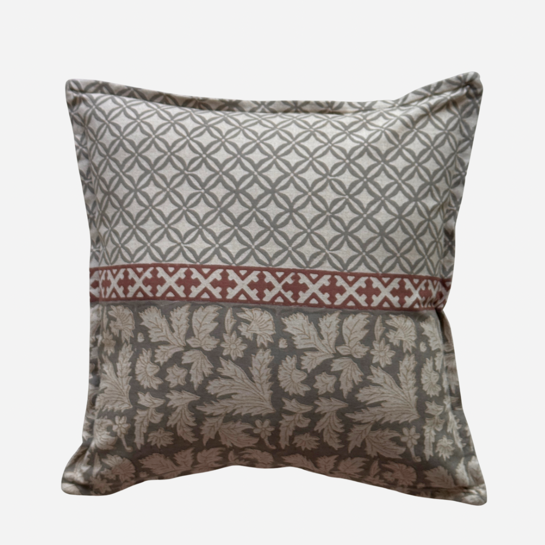A cotton cushion cover with a three-section patterned design: top with a grey geometric lattice pattern, a middle band with a red  geometric motif, and a bottom floral grey damask pattern.