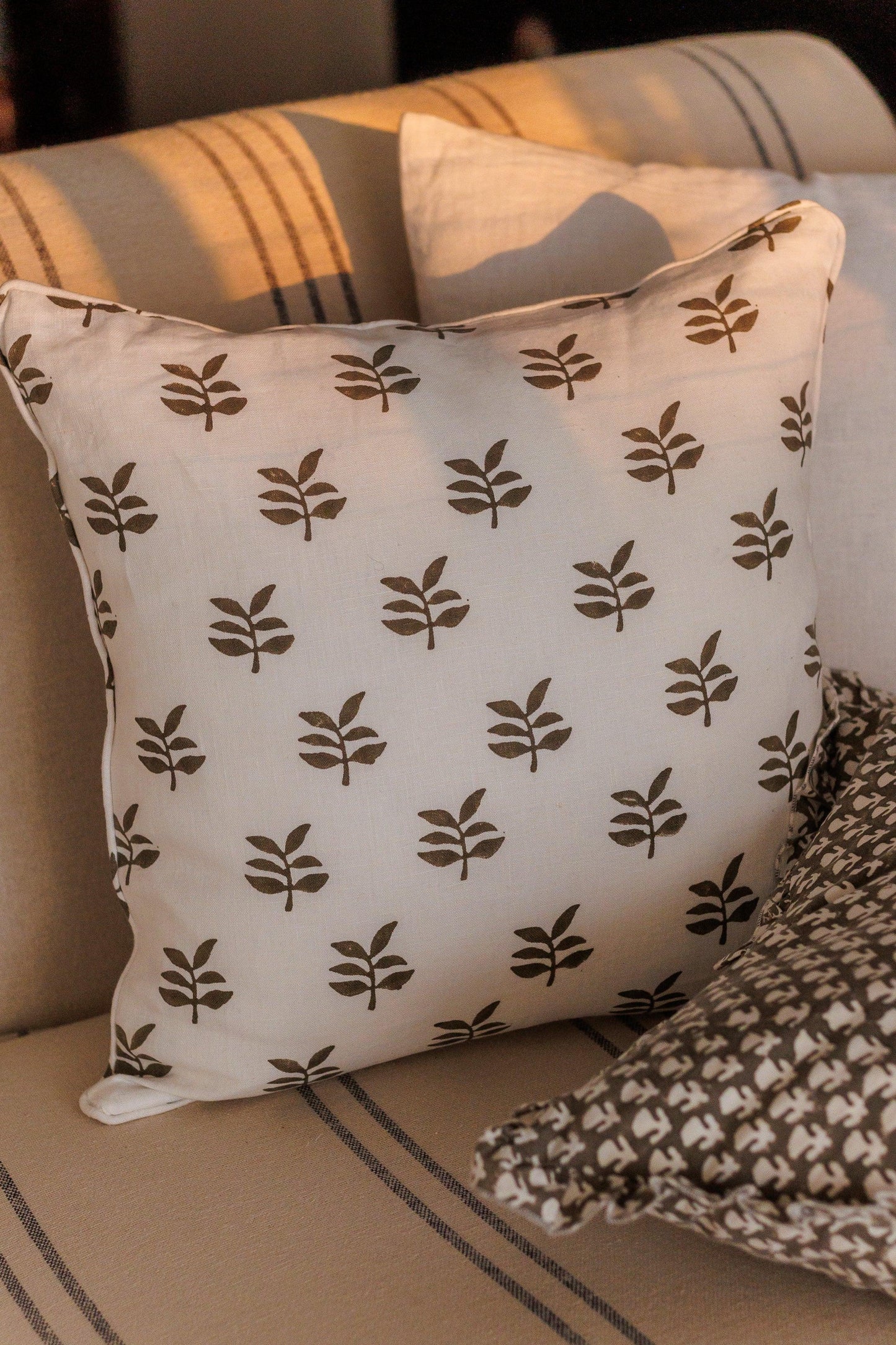 Decorative pillow with leaf pattern on a couch