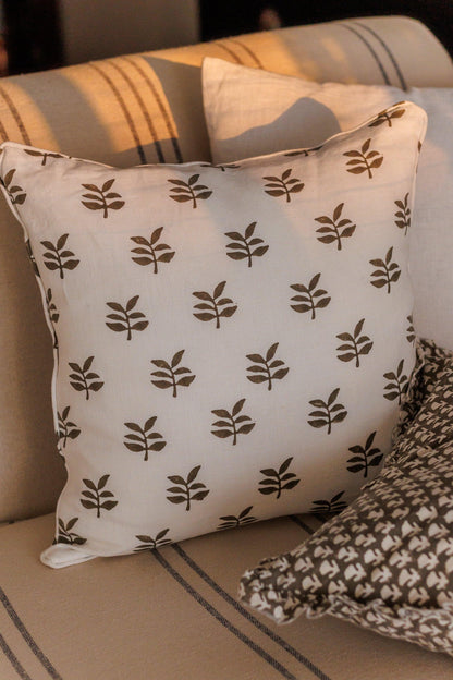 Decorative pillow with leaf pattern on a couch