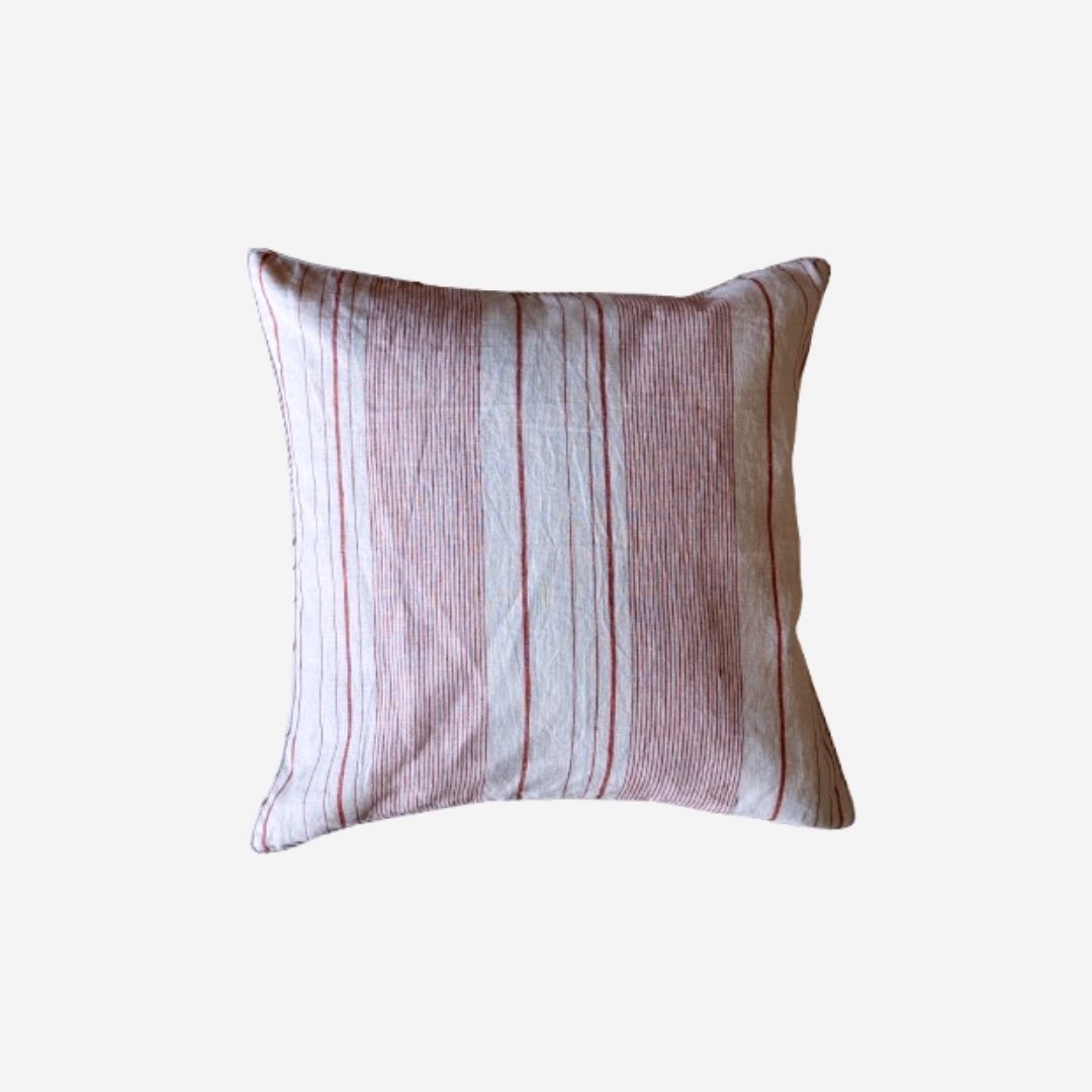 A square throw pillow with a vertical striped pattern in dusty pink, beige, and white, shown against a plain light gray background.