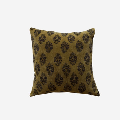A square velvet pillow cover featuring a dark brown damask pattern on an olive green velvet fabric, set against a plain light grey background.