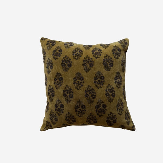 A square velvet pillow cover featuring a dark brown damask pattern on an olive green velvet fabric, set against a plain light grey background.
