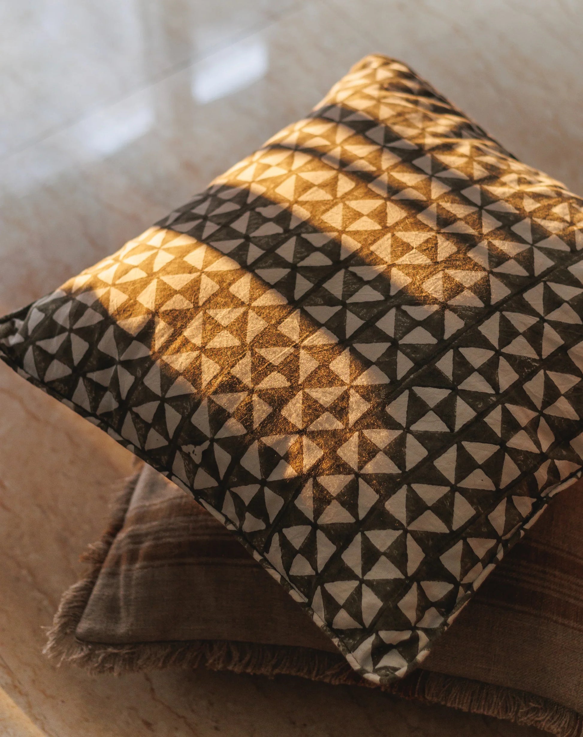 Textured pillow with geometric pattern on a soft surface