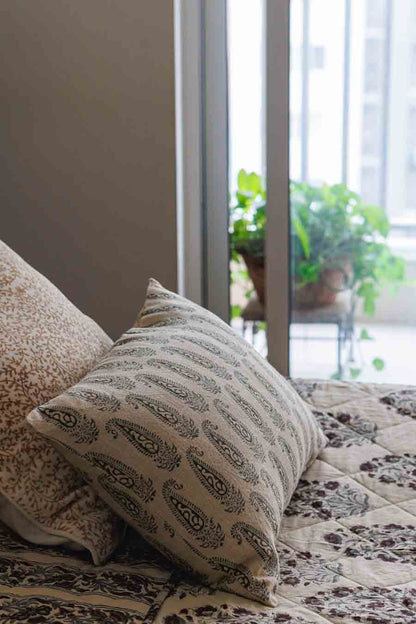 Paisley Block print  Cushion Cover with Block Print quilt placed on bed next to a window and plant