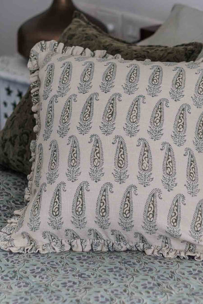 Paisley Pattern Cushion cover in shades of green, featuring ruffles placed on a bed