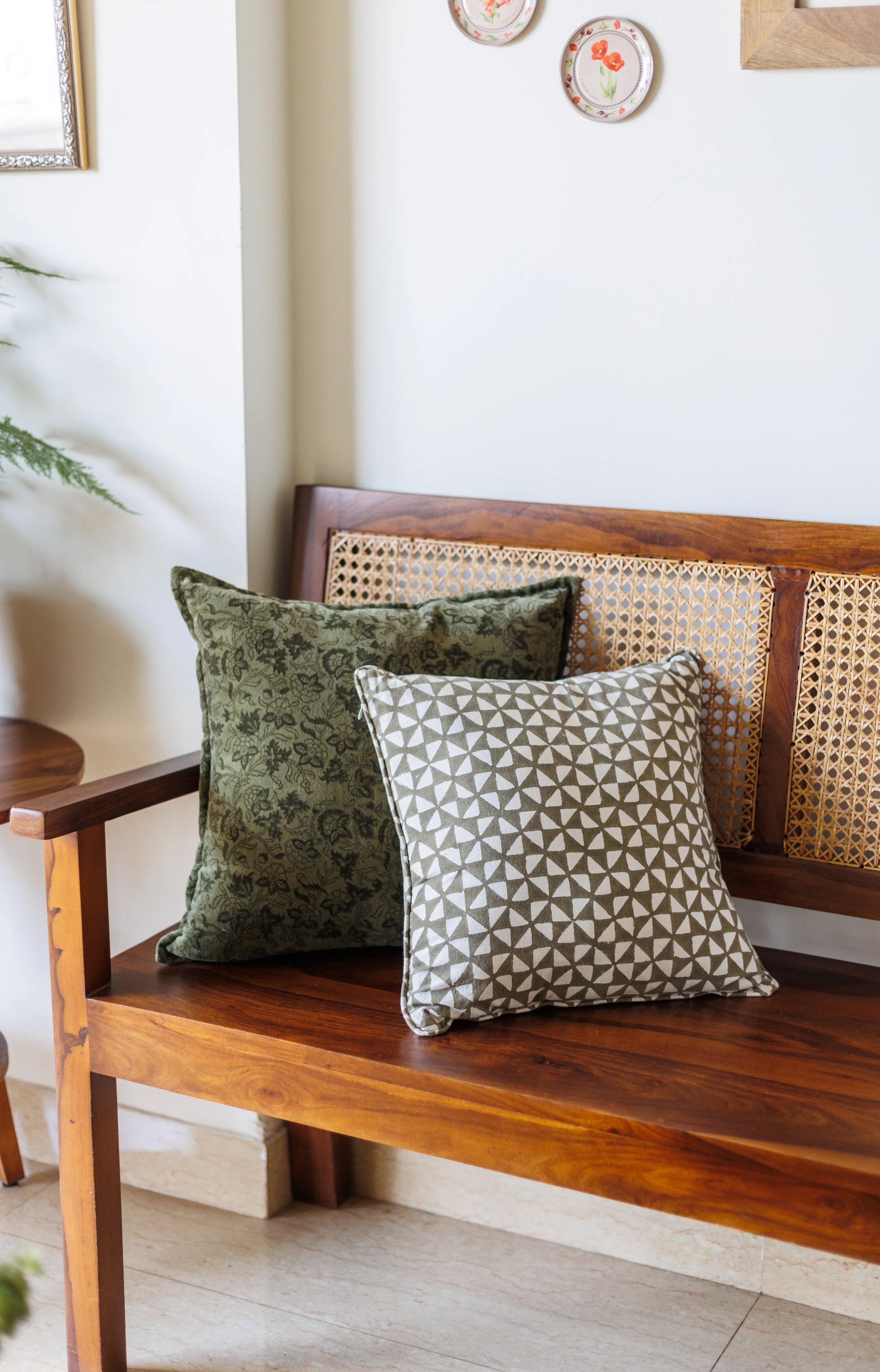 Wooden bench with patterned cushions in a home setting