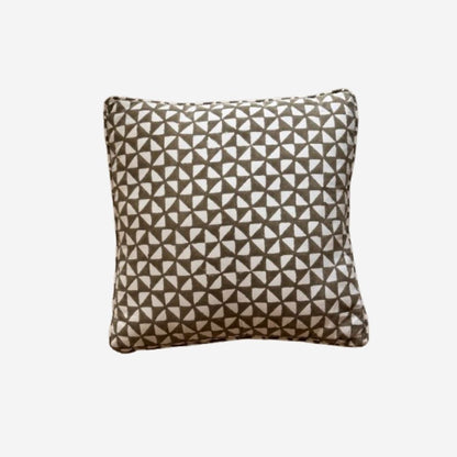 A square throw pillow featuring a geometric triangle pattern in brown and off-white, set against a plain light gray background.