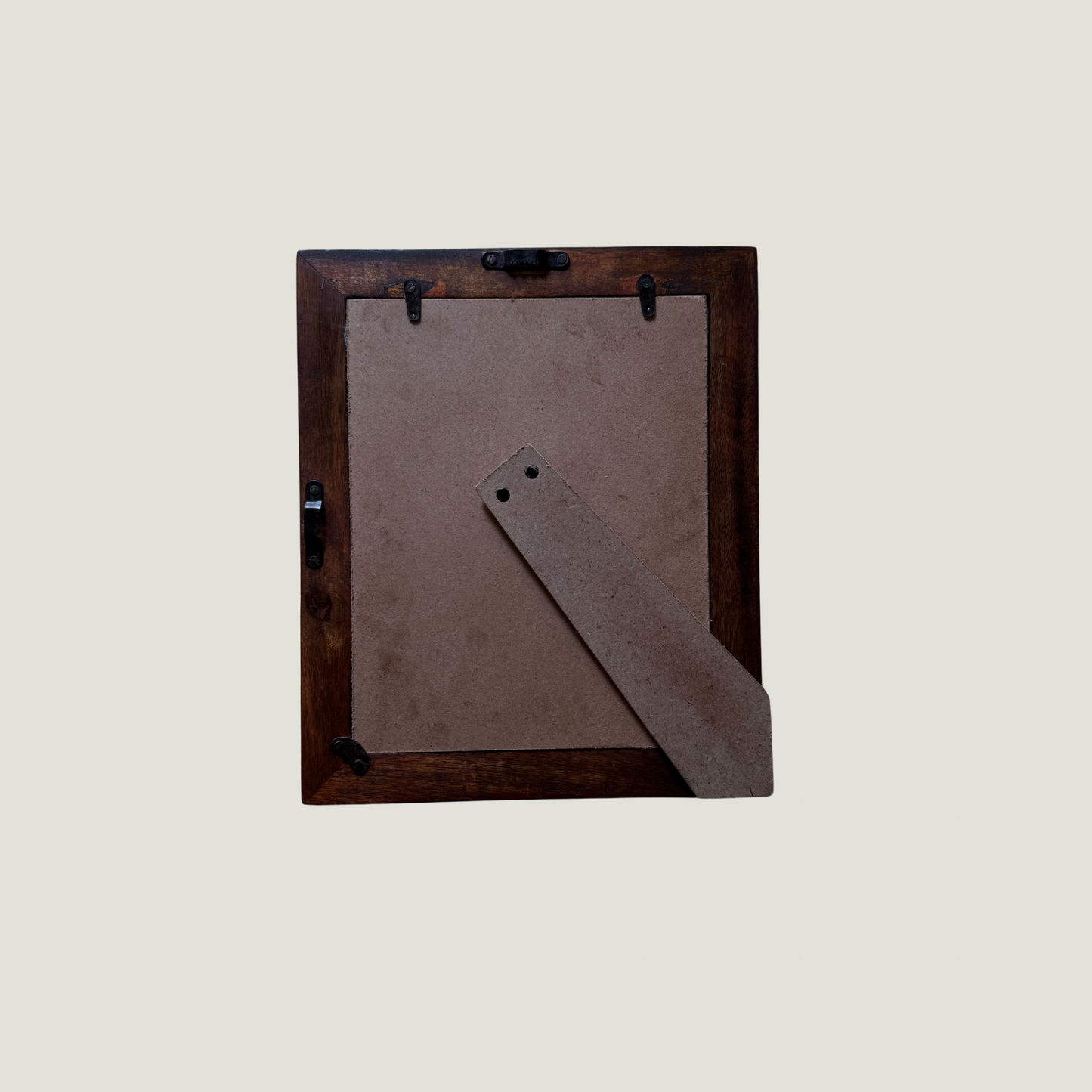 Wooden picture frame with a brown mat on a light gray background