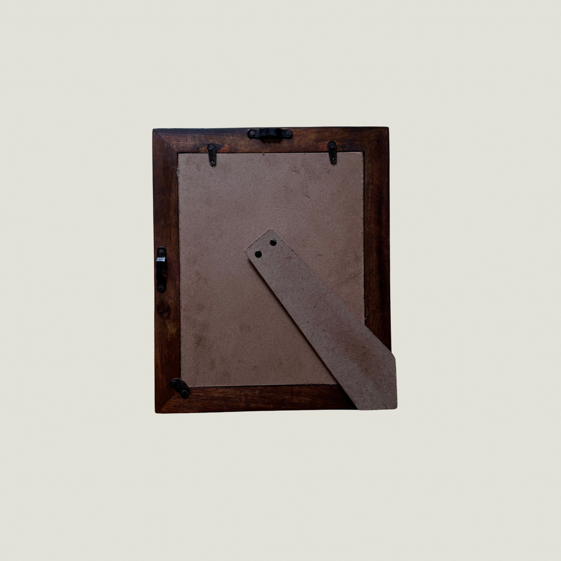 Wooden picture frame with a brown mat on a light gray background