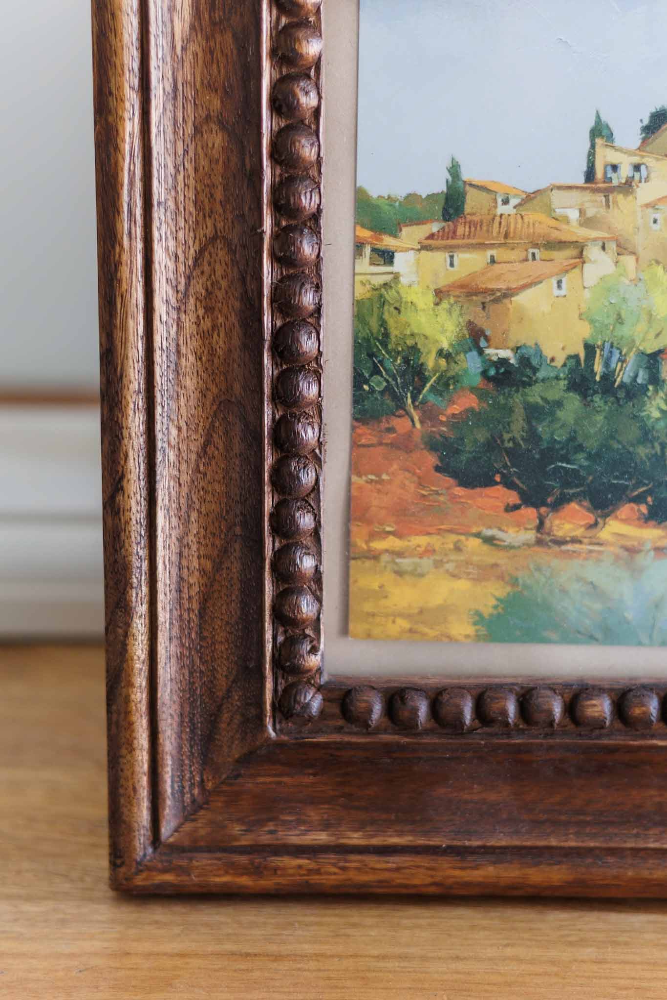 Chunky wooden photo frame showing beaded inner edge and natural wood grain