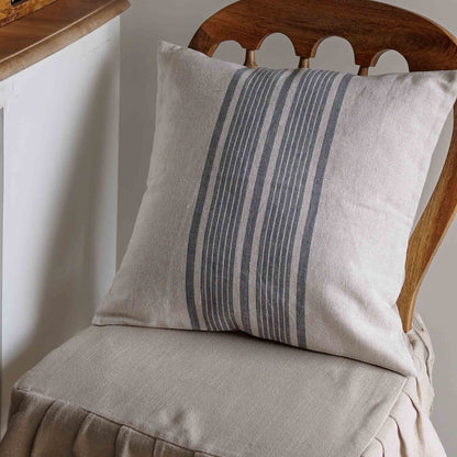 Striped linen pillow on a wooden chair with a neutral background