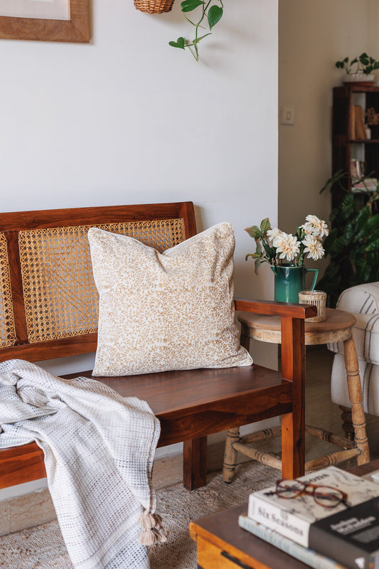 White Block Print Cushion cover on a Wooden Sofa with decor in a living room etting