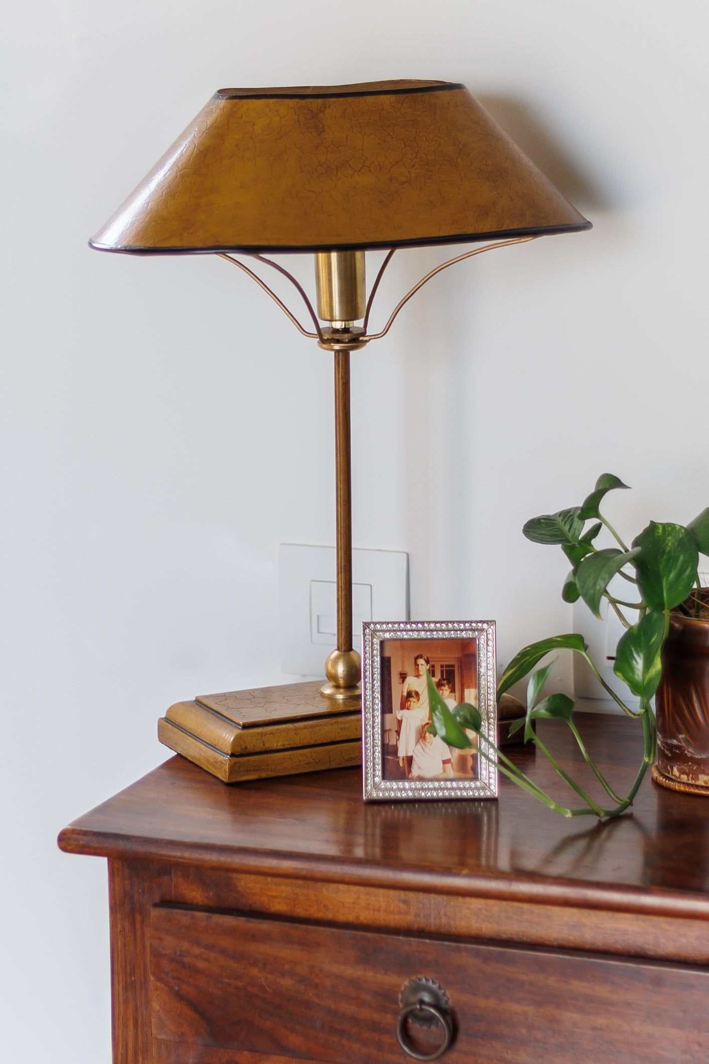 Farmhouse style Manor Table Lamp on nightstand with picture frame and plant