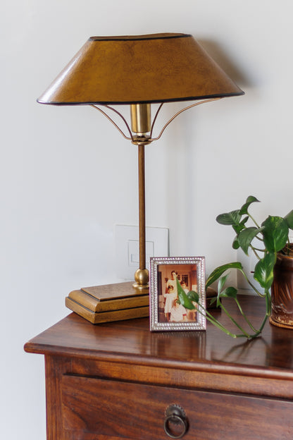 Farmhouse style Manor Table Lamp on nightstand with picture frame and plant