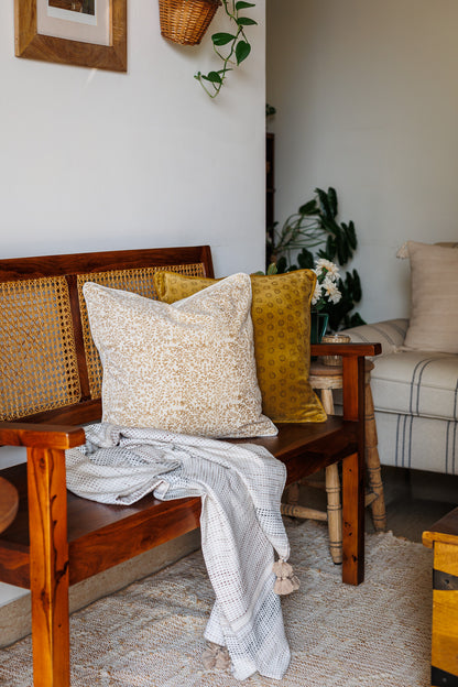 White Block Print Cushion covers on a Wooden Sofa with decor in a living room setting