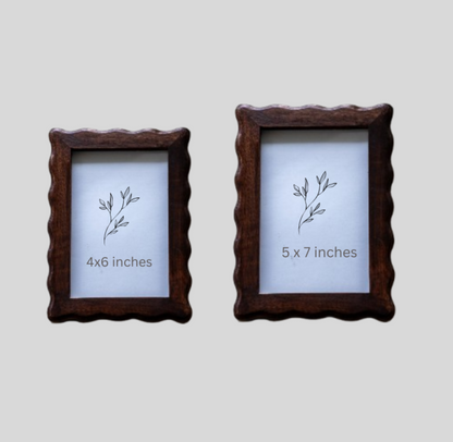 Two wooden picture frames with size labels on a light gray background